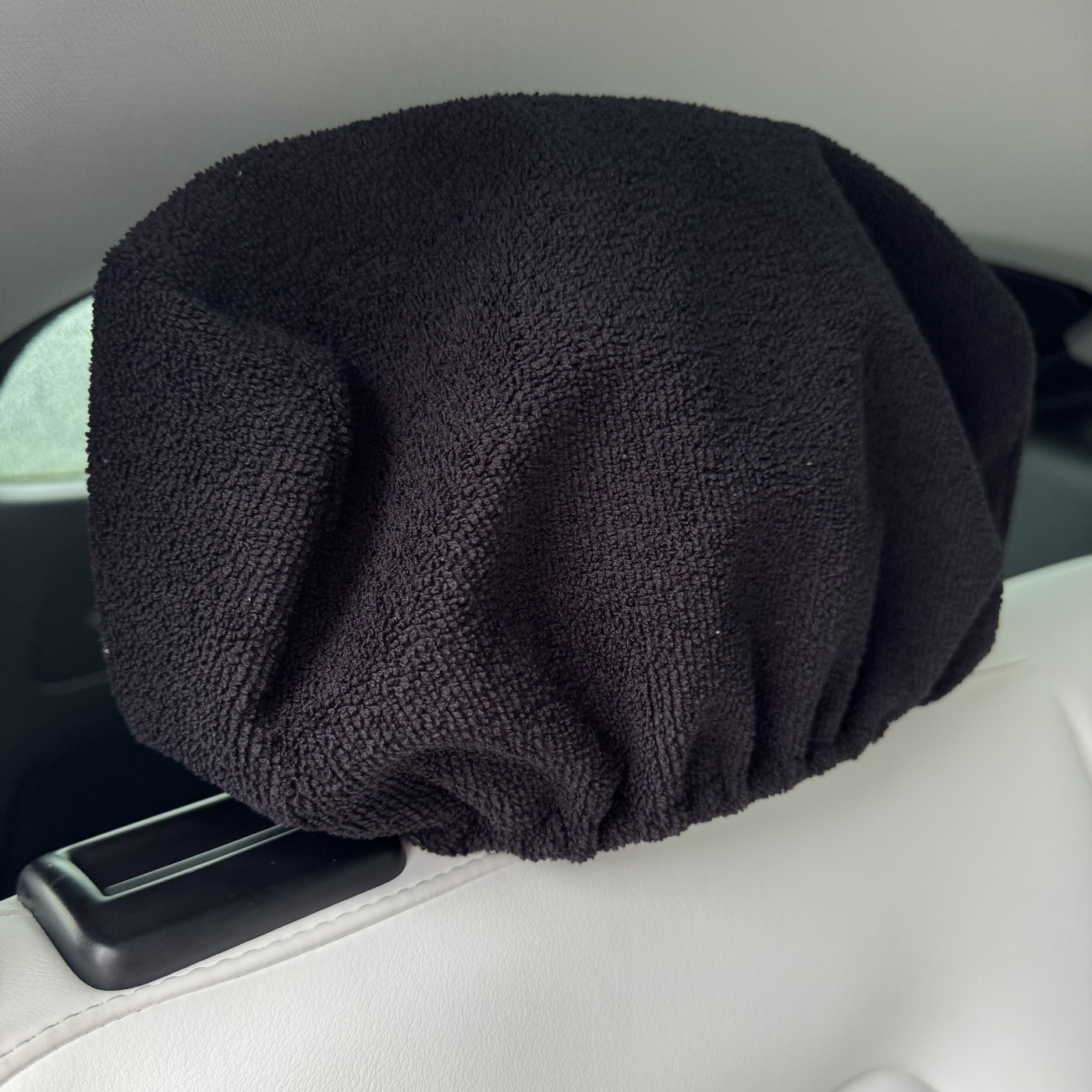 Black headrest cover on a car headrest
