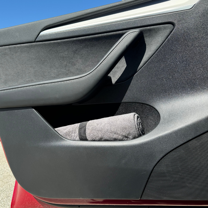 car_seat_towel_grey, rolled in door