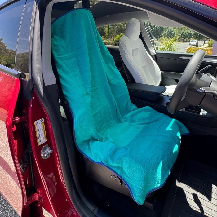 Aqua hooded gym towel covering car seat