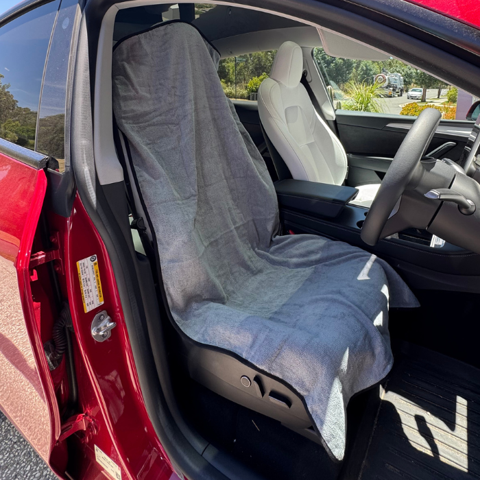Grey gym towel covering car seat